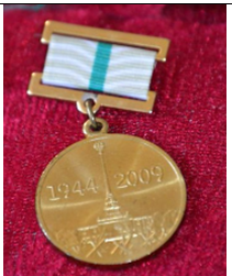 Памятная медаль "В честь 65-летия полного освобождения Ленинграда от фашистской блокады",