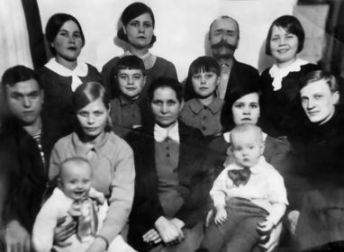 Михаил Кузьмич с супругой Марией Семеновной в кругу родных. Справа от Михаила Кузьмича — его дочь Лидия. Крайний слева — его сын Александр, рядом с ним его жена с ребенком.